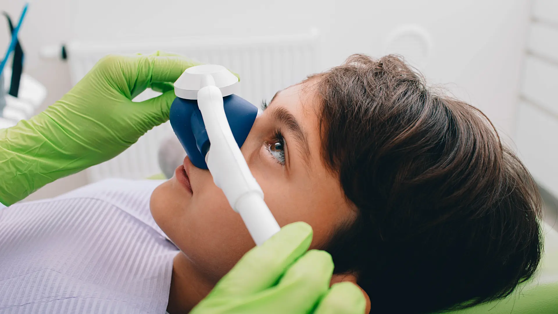 Patient receiving nitrous oxide (laughing gas) sedation during dental treatment.