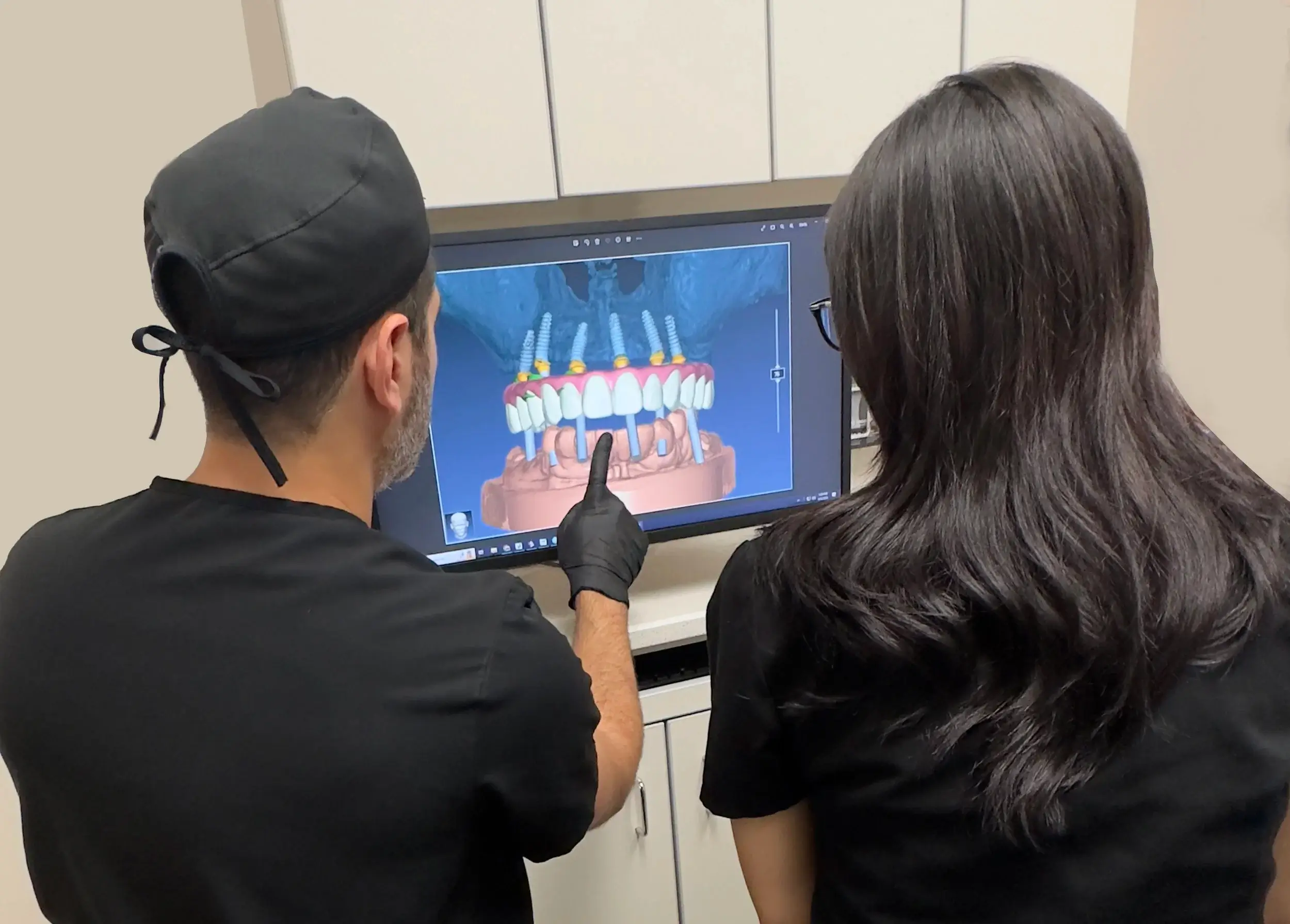 Dental professionals at The Dental Parlour reviewing a digital smile design for a patient.