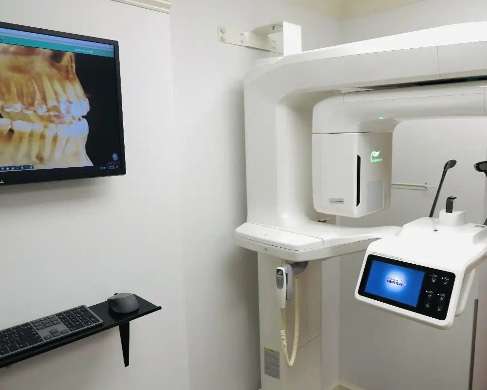Dental cone beam CT scan machine in a clean, modern clinic room.